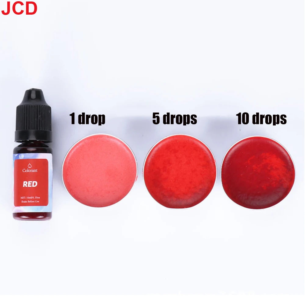 A set of concentrated liquid candle dyes in red color shown with dropper bottles and various amounts of red dye drops