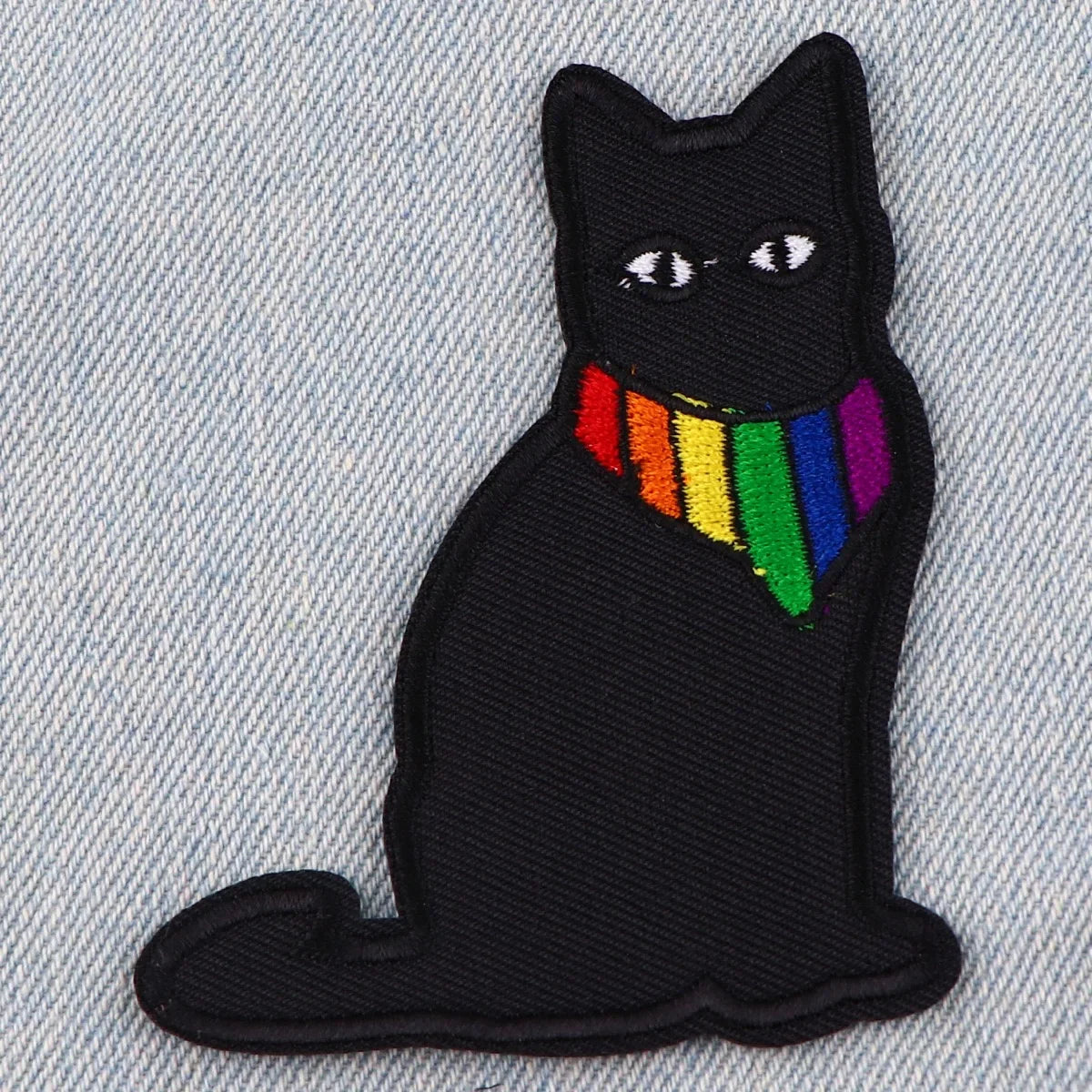 Black embroidered cat dragon iron-on patch featuring a rainbow collar