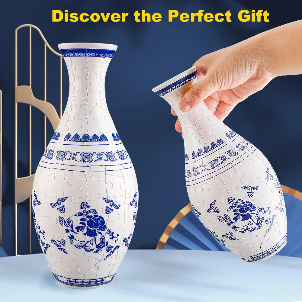 A hand is holding a white ceramic vase with blue floral patterns, demonstrating the 3D puzzle design.