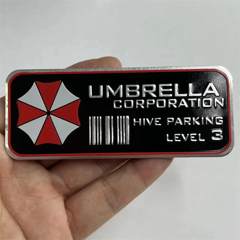 A close-up of an aluminum alloy honeycomb metal sticker with the text Umbrella Corporation and Hive Parking Level 3 printed o