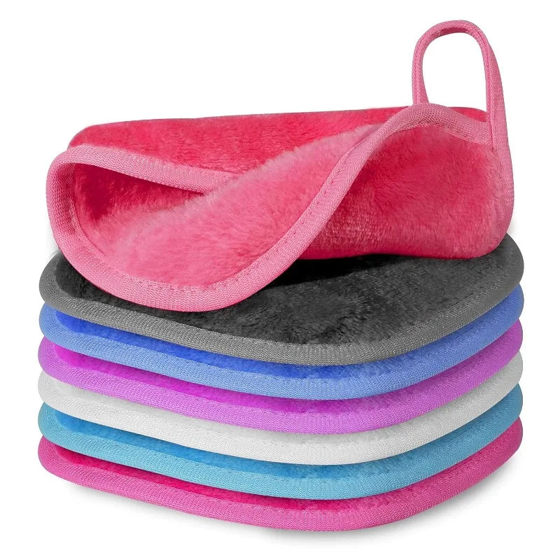 A set of five pink and gray reusable makeup remover cloths stacked together.