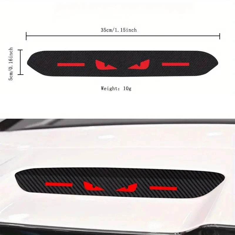 Black brake light sticker with red accents applied to a white car body panel.