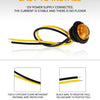 A yellow LED side marker light connected to a 12V power supply, showing the wire connections and protective materials.
