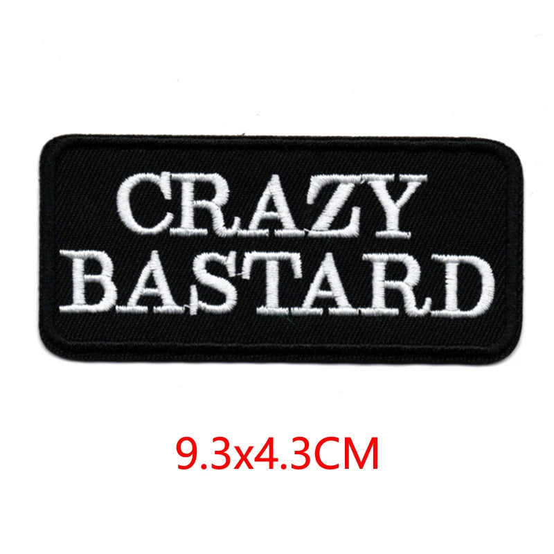 Black embroidered iron-on letter patch with white text CRAZY BASTARD
