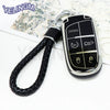 A black TPU car key fob cover with panic and lock buttons attached to a black braided lanyard.