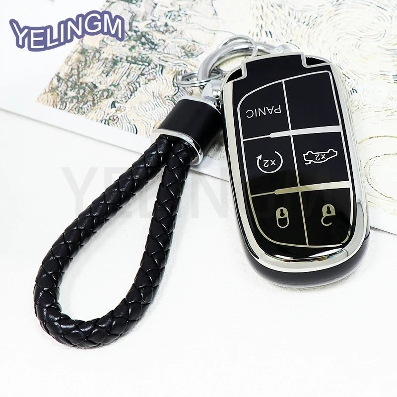 A black TPU car key fob cover with panic and lock buttons attached to a black braided lanyard.
