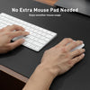 Hands are using a white keyboard and mouse on a dark desk surface, demonstrating smooth mouse usage.