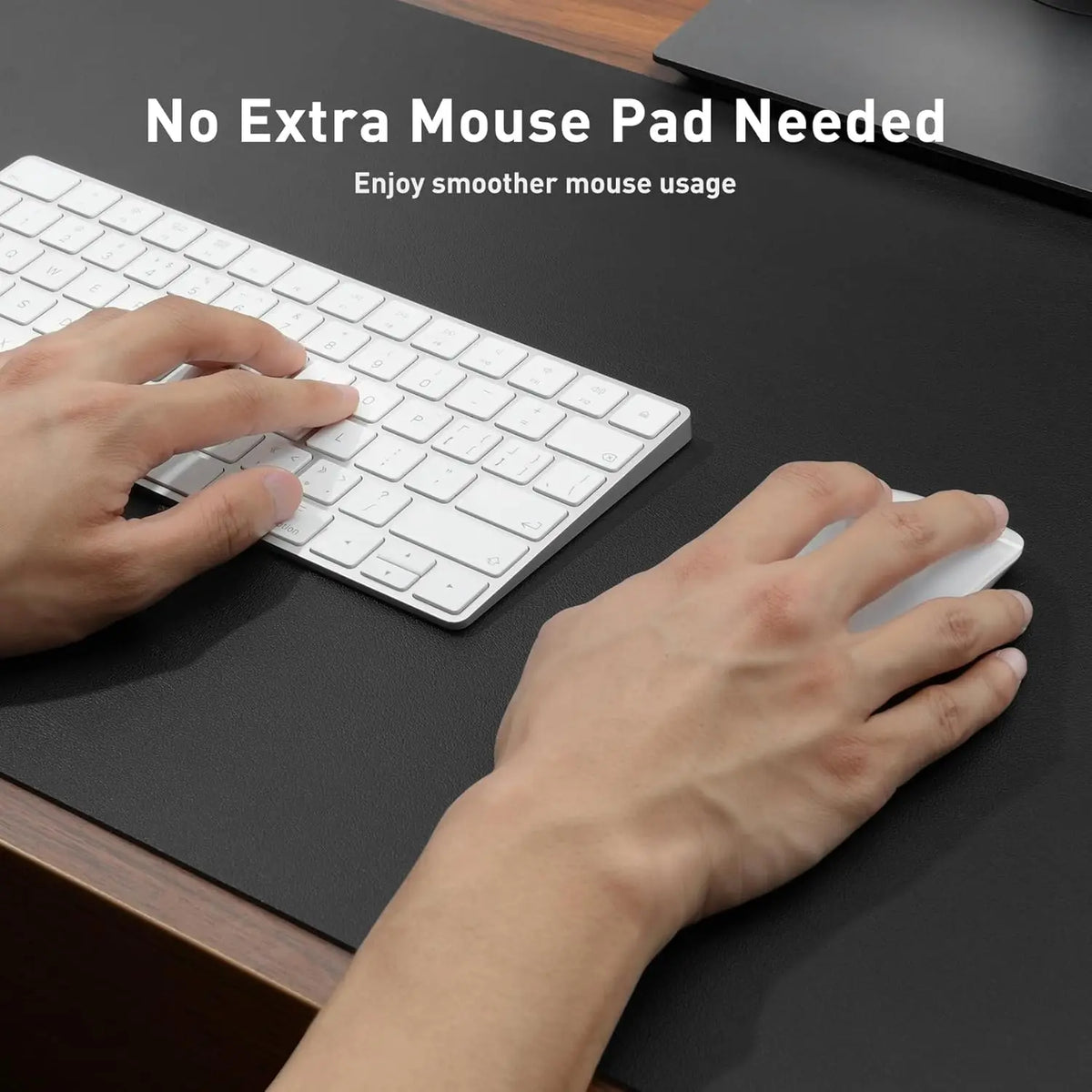 Hands are using a white keyboard and mouse on a dark desk surface, demonstrating smooth mouse usage.