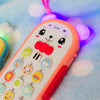 An orange musical teether phone toy with purple lights and buttons resting on a light blue surface.