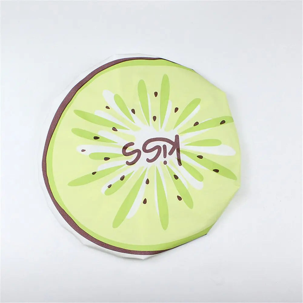 A round, lime green fruit-design waterproof shower cap for women featuring a kiwi pattern.