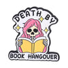 Enamel pin featuring a skull with pink hair and the text Death By Book Hangover