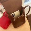 A brown vintage PU leather crossbody shoulder bag is shown open, displaying a light-colored smartphone inside.