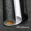 Roll of black embossed silk self-adhesive wallpaper shown against a dark background.