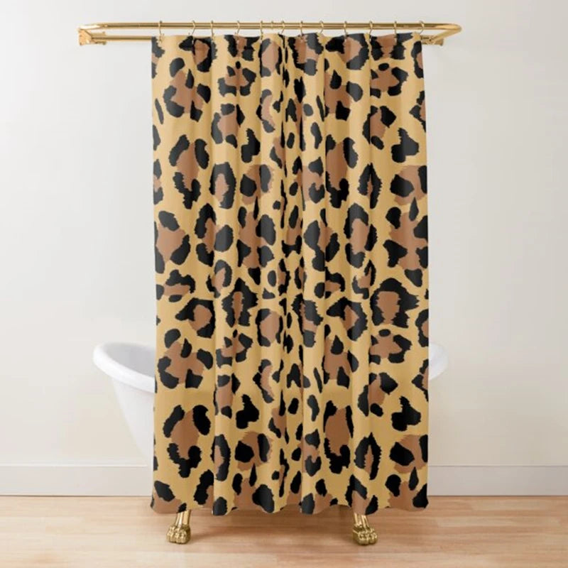 A tan and black leopard print shower curtain hanging from a gold rod.
