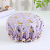 A purple reusable elastic shower cap decorated with gold deer and foliage patterns.
