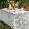 Elegant white lace tablecloth with French retro floral design set for a wedding or party.