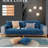 A deep blue velvet sofa cover with light gray cushions and a matching rug displayed against a dark wall.