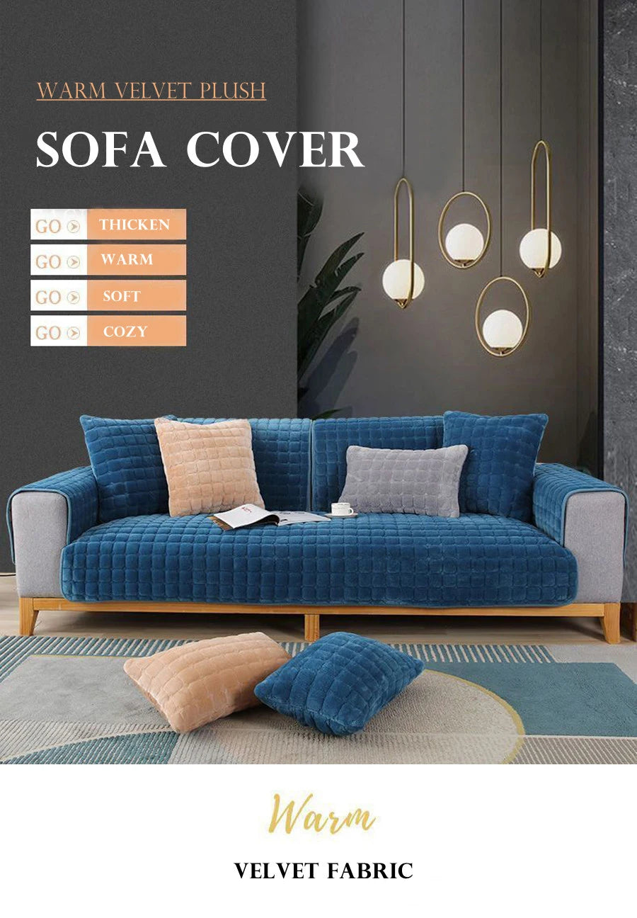 A deep blue velvet sofa cover with light gray cushions and a matching rug displayed against a dark wall.