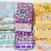 A collection of 40 floral cotton fabric strips in various colors and patterns for quilting and patchwork projects.