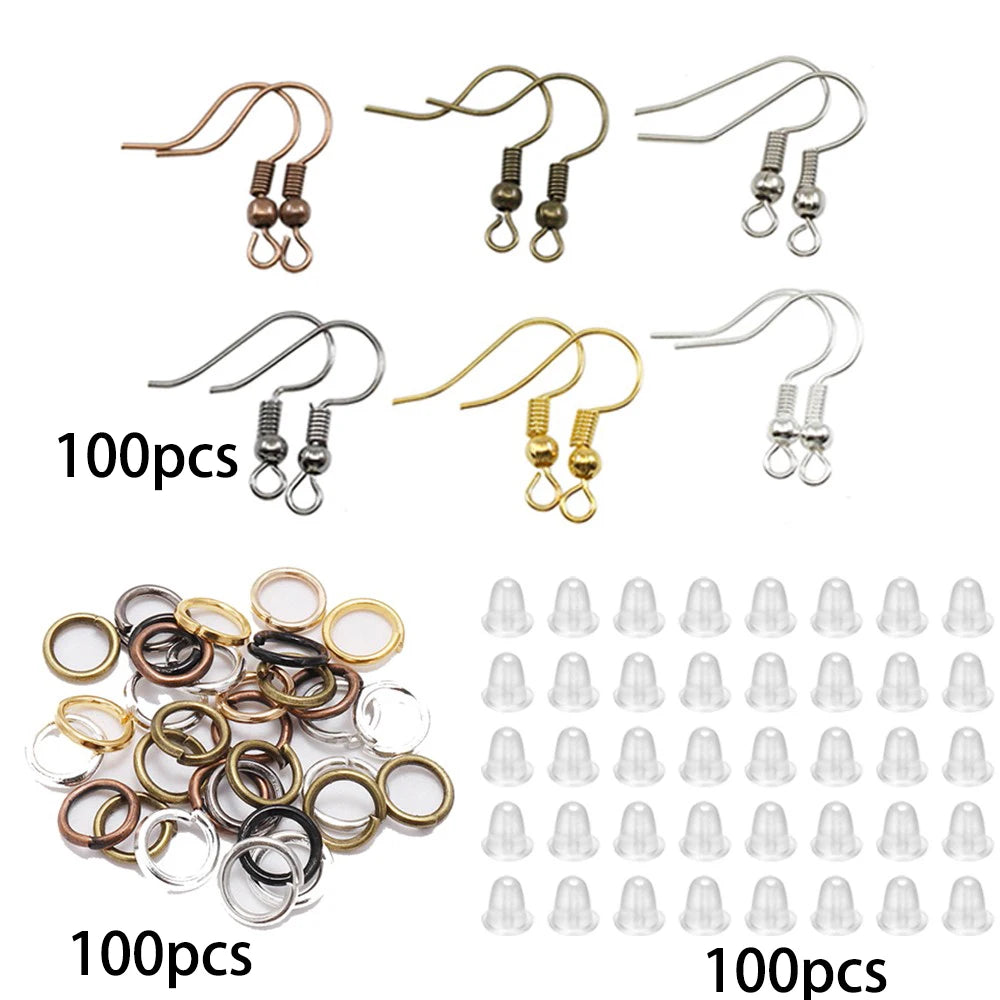 Assortment of jewelry making components including lobster clasps, jump rings, and crimps.