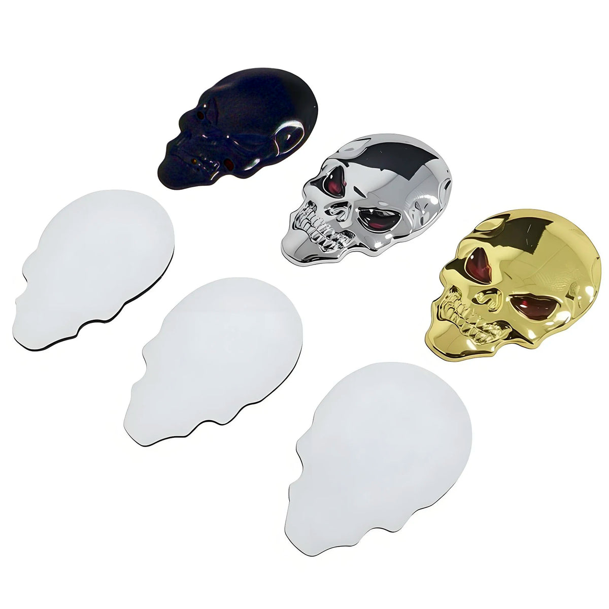 Three skull emblems in chrome, silver, and gold finishes displayed against a white background.