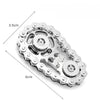 A silver alloy sprocket fidget spinner with a decorative edge and a central rotating mechanism.