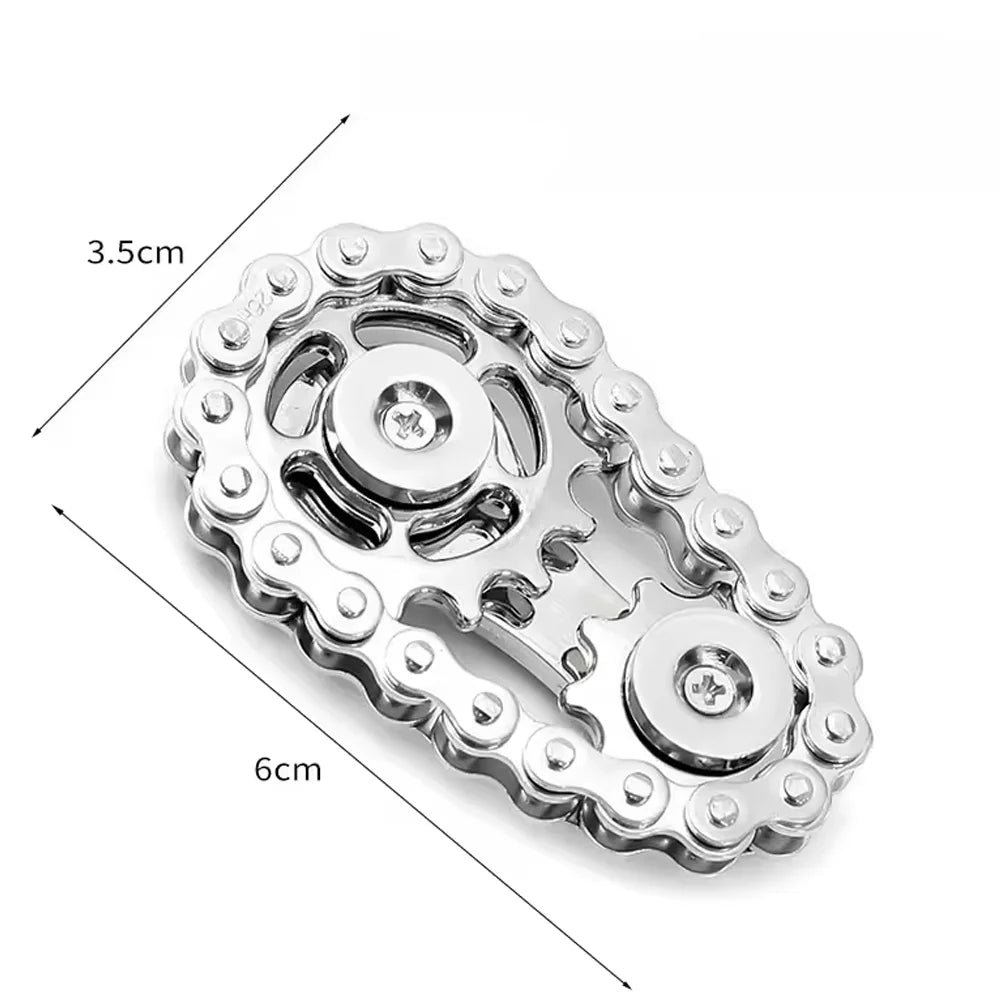 A silver alloy sprocket fidget spinner with a decorative edge and a central rotating mechanism.