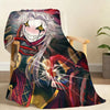 A throw blanket featuring a stylized illustration of Pierrot with white hair and a wide smile in circus attire.
