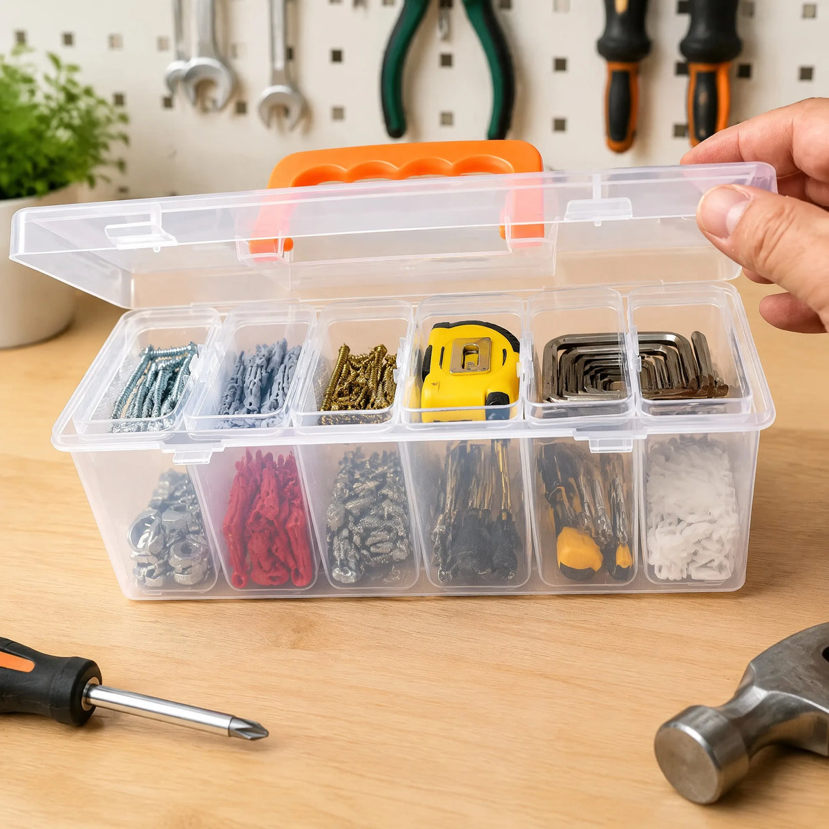 A hand holds a transparent multi-compartment hardware storage box filled with various colored and textured hardware items.
