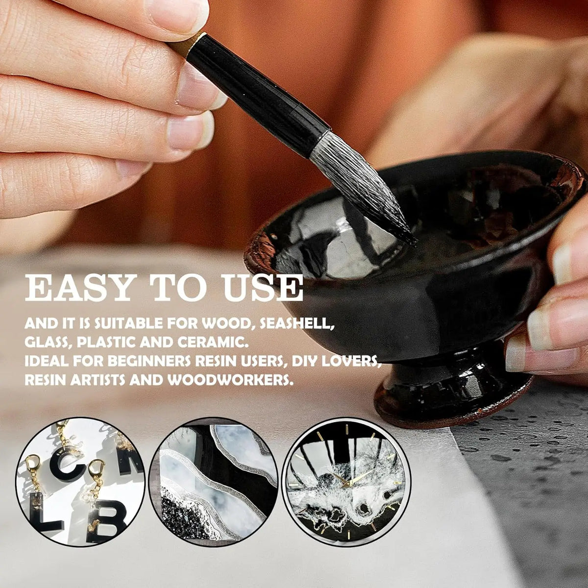 A hand is using a brush to apply black epoxy resin pigment onto a dark bowl for art purposes.