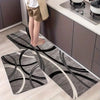 A long rectangular rug with black and white geometric swirling patterns placed on a light wood floor.