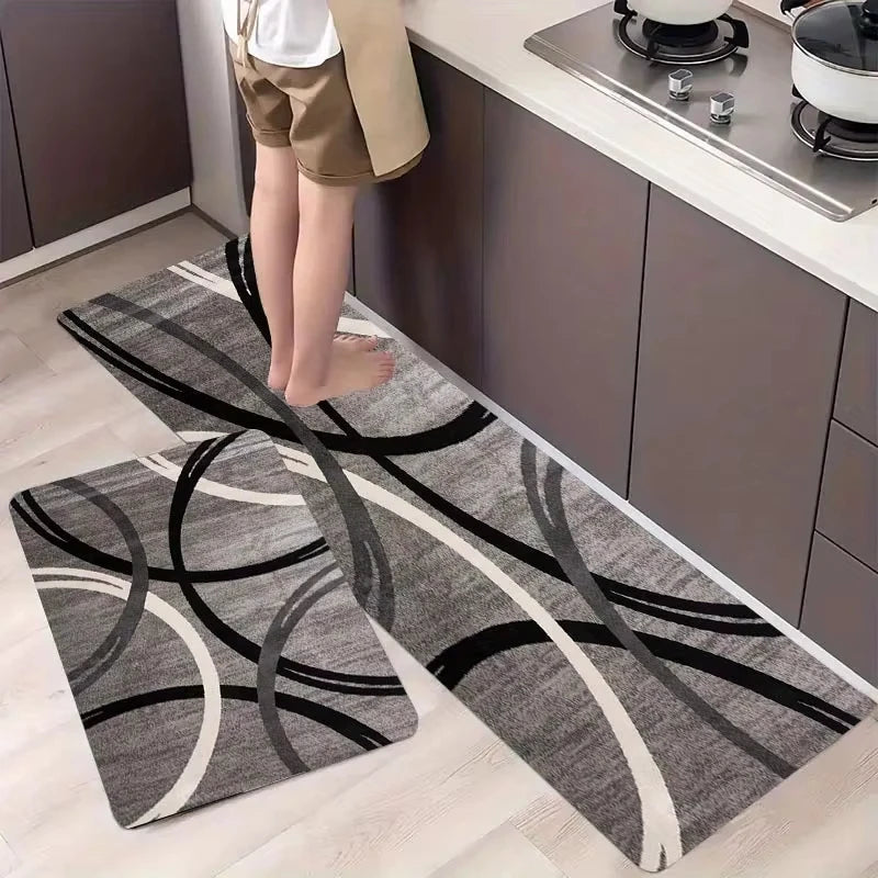 A long rectangular rug with black and white geometric swirling patterns placed on a light wood floor.