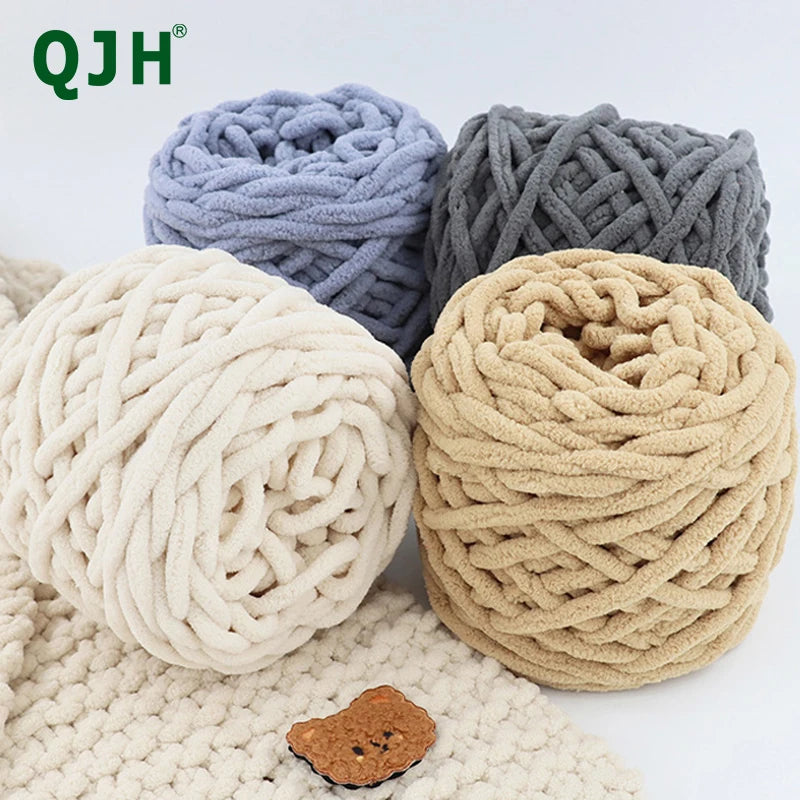 Three skeins of chunky chenille yarn in light blue, gray, and beige are displayed on a white surface.