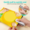 Hands are gently pulling a food bag sealed with a portable 2-in-1 bag sealer and cutter.