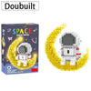 A box of Doubuilt Space Travel building blocks featuring an astronaut on a golden moon background.