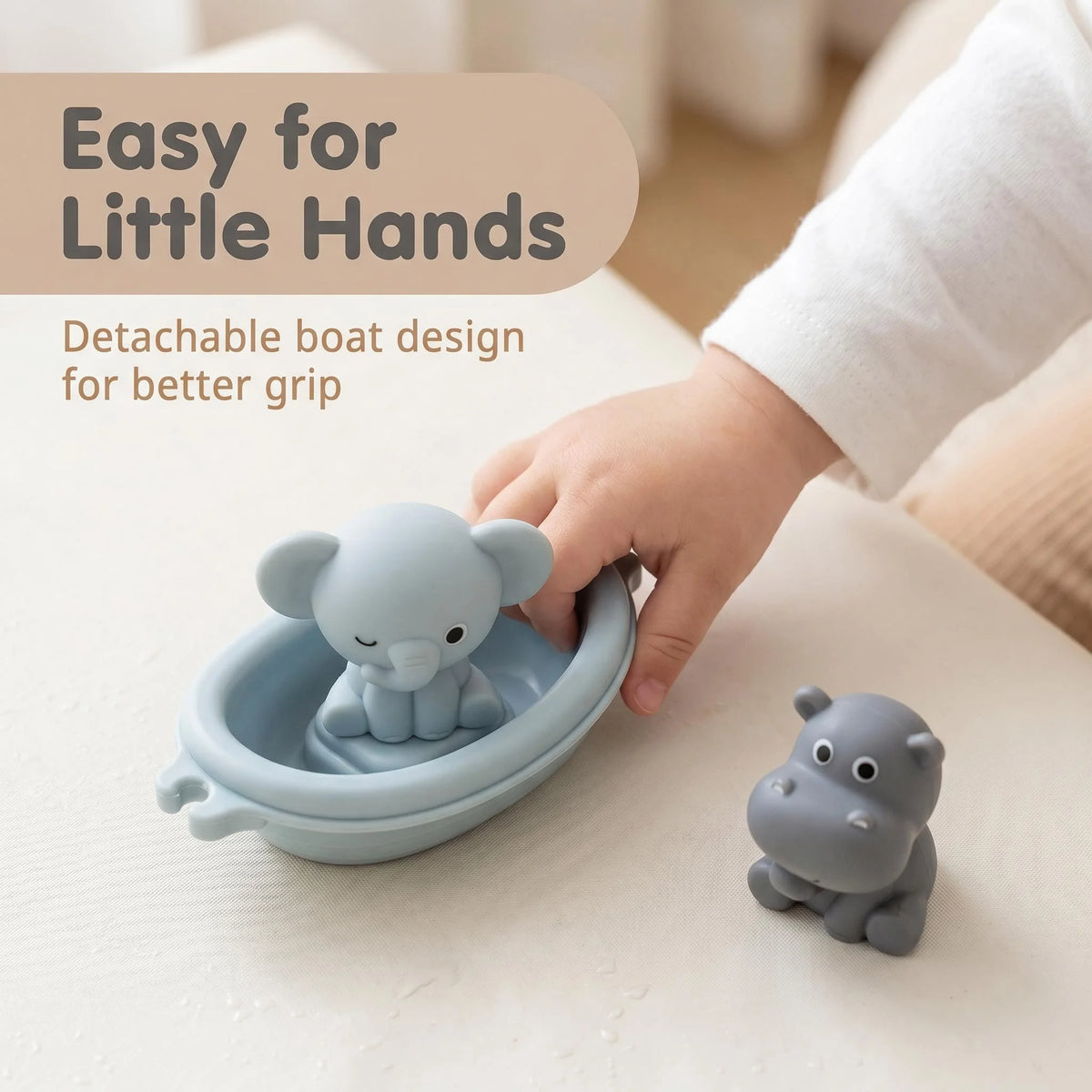 A child's hand is holding a light blue silicone boat toy designed for little hands.