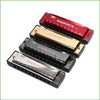 A set of three harmonica models, including a red, gold, and silver 10-hole diatonic harmonica, displayed in protective cases.