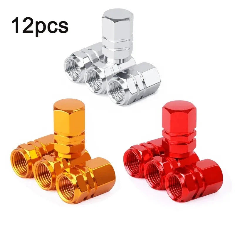 Twelve metal valve caps in silver, gold, and red colors for automotive tires