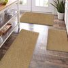 A row of natural fiber kitchen runner rugs in beige and tan are laid out on a light wood floor near a window.