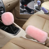A set of plush pink car gear shift and handbrake covers shown in various angles inside a vehicle cabin.