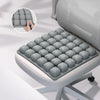 A gray adjustable press-to-inflate seat cushion with individual air cells shown in a close-up view.