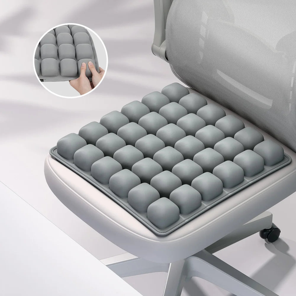 A gray adjustable press-to-inflate seat cushion with individual air cells shown in a close-up view.