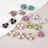 A collection of 20 pearlized resin flower beads in various shades of blue, purple, and white clustered on a white background.