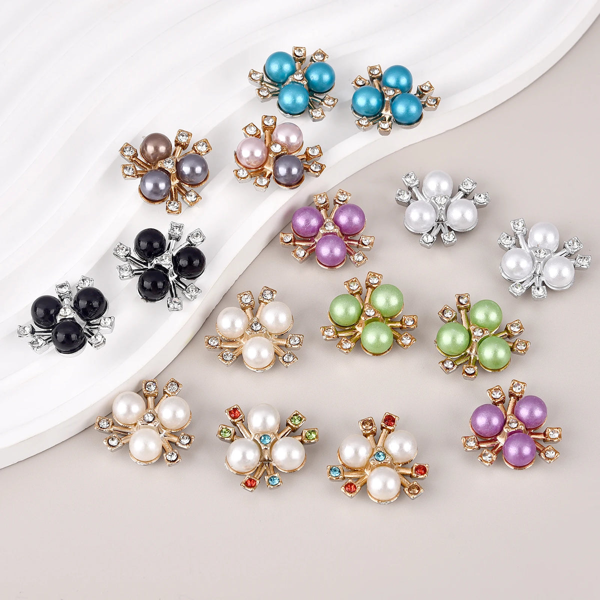 A collection of 20 pearlized resin flower beads in various shades of blue, purple, and white clustered on a white background.
