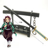 A miniature replica of a katana sword with a decorative hilt and scabbard, displayed next to an anime-style character figure.