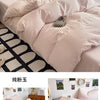 A set of four ultra-soft washed cotton duvet covers in a pale pink color displayed on a bed.