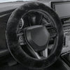 Close-up view of a black winter plush steering wheel cover on a car interior.