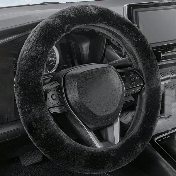 Close-up view of a black winter plush steering wheel cover on a car interior.