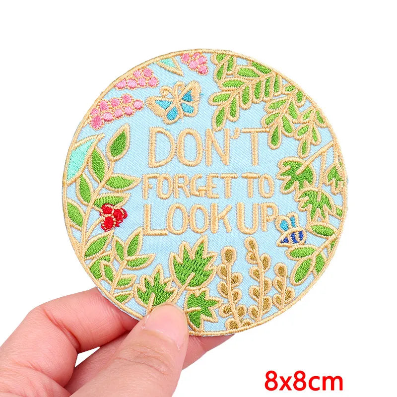 Light blue embroidery patch featuring a floral design with the text DON'T FORGET TO LOOK UP