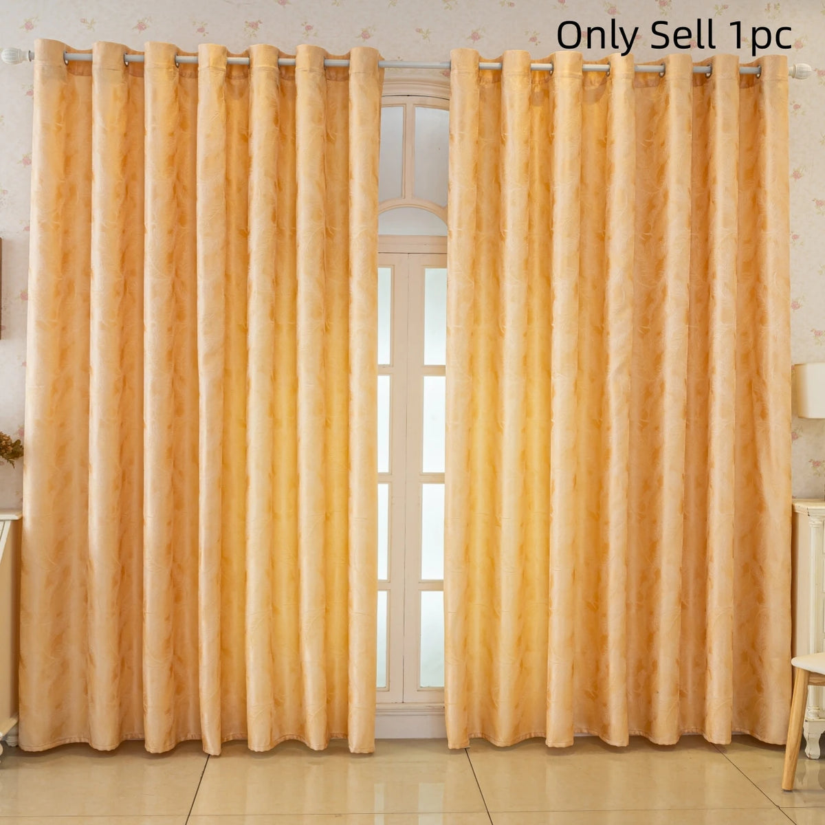 A pair of sheer gold curtains with a feather jacquard pattern hanging in a window.